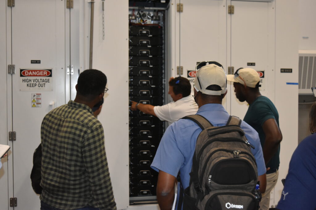 people looking at an electric board