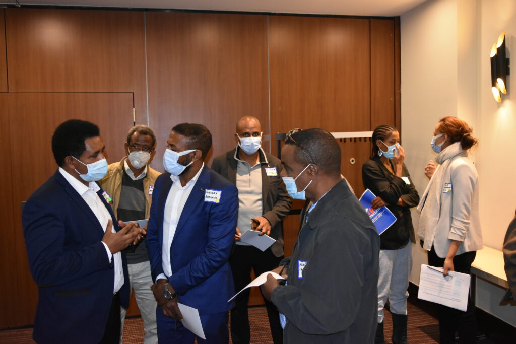 people in suits standing together in a room