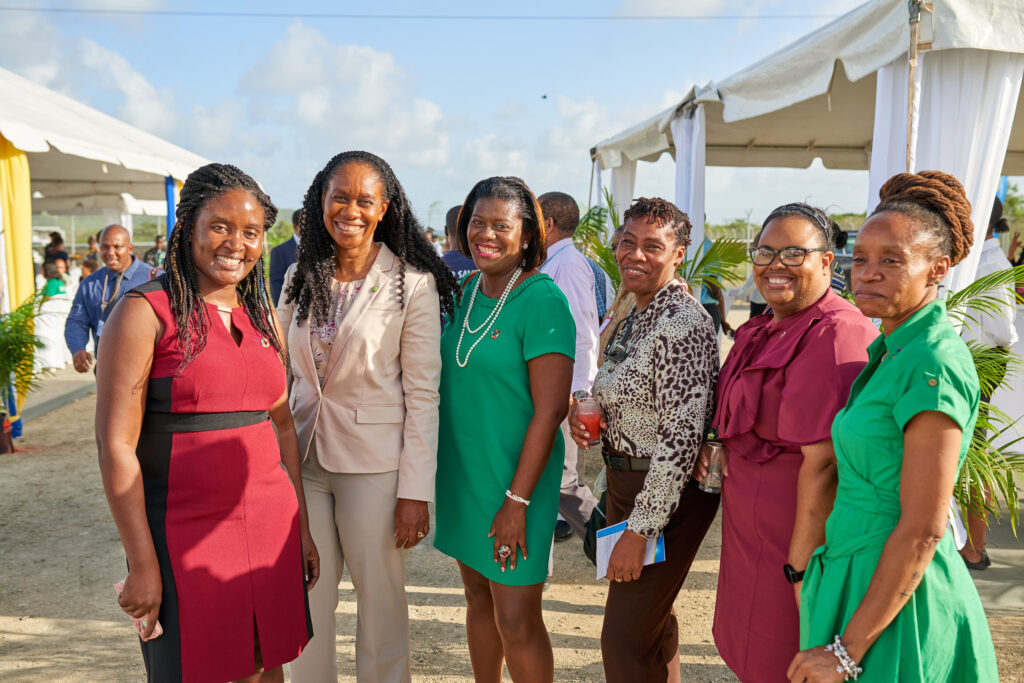 women in professional clothes standing smiling