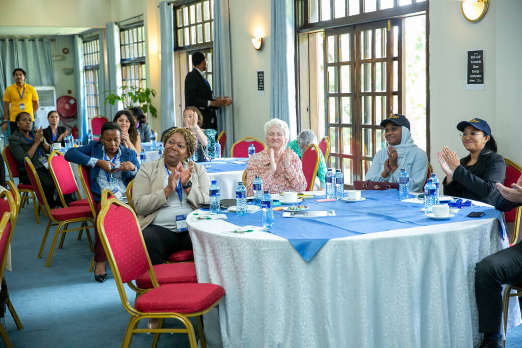 Group of people sitting at tables and clapping